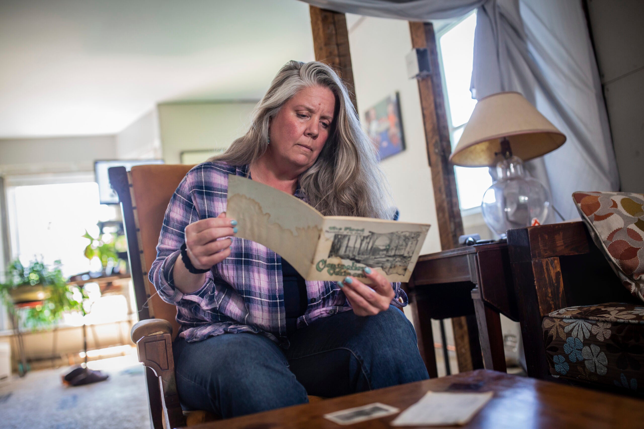 Lisa Edson Neveu reads a brochure at her house in Montpelier, Vt.