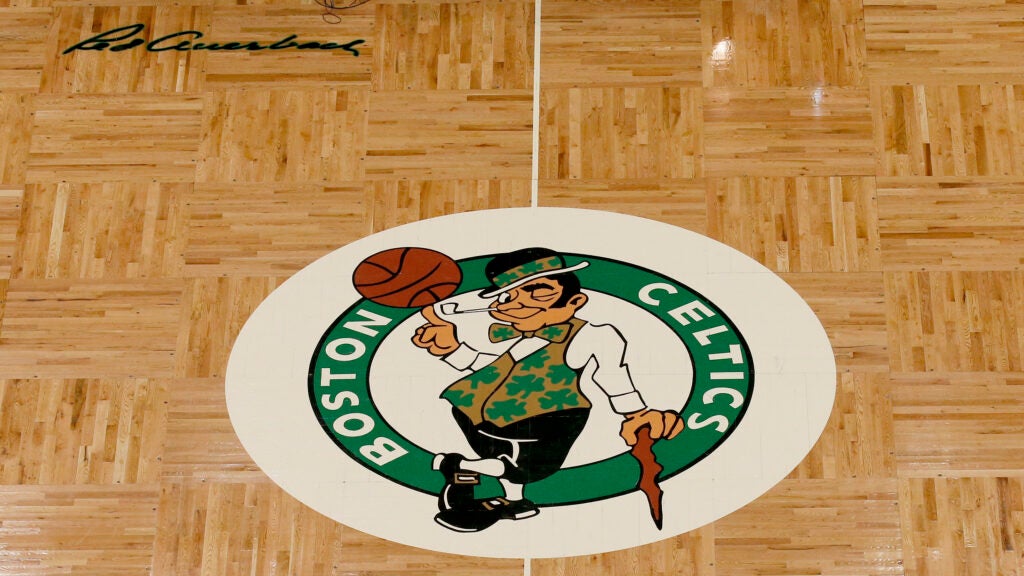 The Boston Celtics logo and Red Auerbach signature are seen on the TD Garden parquet floor before the start of an NBA basketball game, Wednesday, Feb. 27, 2019, in Boston.