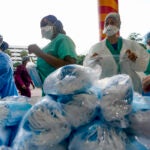 Healthcare workers line up for free personal protective equipment in Miami.