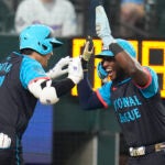 National League's Shohei Ohtani, of the Los Angeles Dodgers, left, celebrates his three-run home with Jurickson Profar, of the San Diego Padres, in the third inning during the MLB All-Star baseball game in Texas.