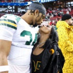 Green Bay Packers safety Jonathan Owens and Simone Biles kiss before an NFL football NFC divisional playoff game between the Packers and the San Francisco 49ers.