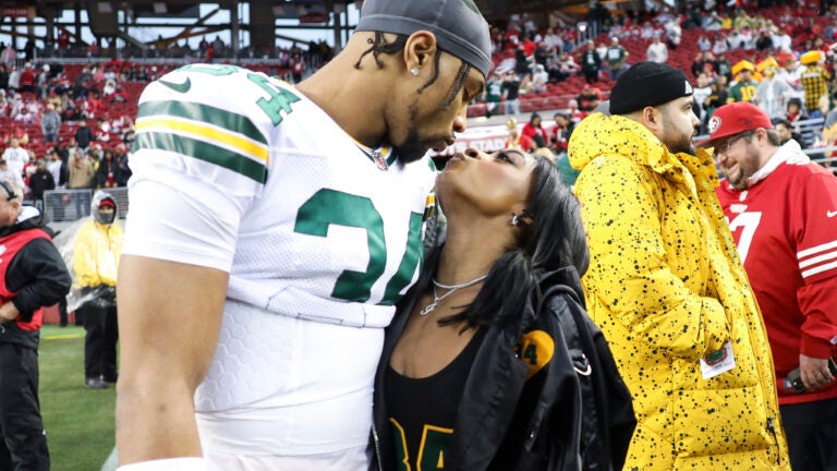 Green Bay Packers safety Jonathan Owens and Simone Biles kiss before an NFL football NFC divisional playoff game between the Packers and the San Francisco 49ers.