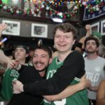 Celtics fans Michael Cole and Owen Maceachern hug at The Greatest Bar.