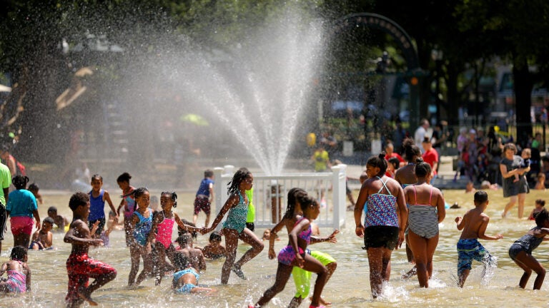 Children cool off in the Frog pond.