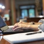 A person uses a laptop computer while working from home.