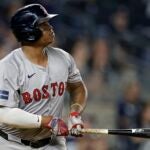 NEW YORK, NEW YORK - JULY 07: Rafael Devers #11 of the Boston Red Sox hits a solo home run in the ninth inning against the New York Yankees at Yankee Stadium on July 7, 2024 in New York City. The Red Sox won 3-0.