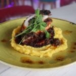 El Ocho octopus tentacle on gold potato purée, drizzled with sauce