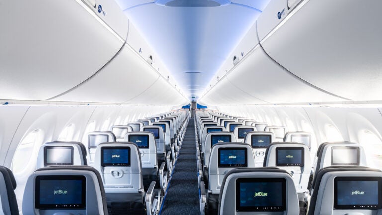 The interior of JetBlue's A220 aircrafts, with more legroom and larger overhead bins.