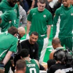 Celtics head coach Joe Mazzulla, center, speaks to his players during a timeout in the first half of Game 5 of the NBA Finals against the Dallas Mavericks.