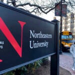 A picture of a black Northeastern University campus sign.