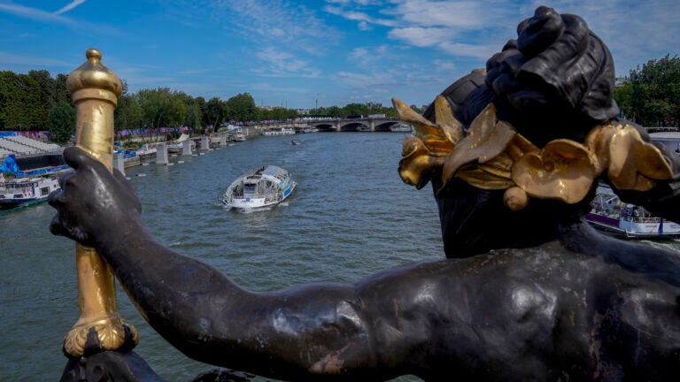 A tourist boat makes its way along the Seine River by the Alexandre III bridge, at the 2024 Summer Olympics.