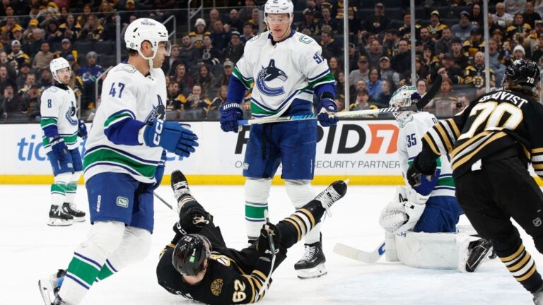 BOSTON, MASSACHUSETTS - FEBRUARY 08: Nikita Zadorov #91 of the Vancouver Canucks shoves Oskar Steen #62 of the Boston Bruins during the third period at the TD Garden on February 8, 2024 in Boston, Massachusetts. The Bruins won 4-0.