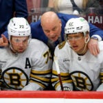 Boston Bruins head coach Jim Montgomery talking to defenseman Charlie McAvoy (73) and defenseman Hampus Lindholm (27) moments after Florida Panthers scored the first goal of the game during second period in game one of the Eastern Conference NHL Playoffs at Amerant Bank Arena.