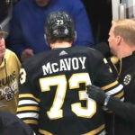 Boston Bruins defenseman Charlie McAvoy heads to the locker room after after a 3rd period collision with Sabres JJ Peterka. He left the game.