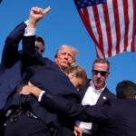 Republican presidential candidate former President Donald Trump is surrounded by U.S. Secret Service agents at a campaign rally, Saturday, July 13, 2024, in Butler, Pa.