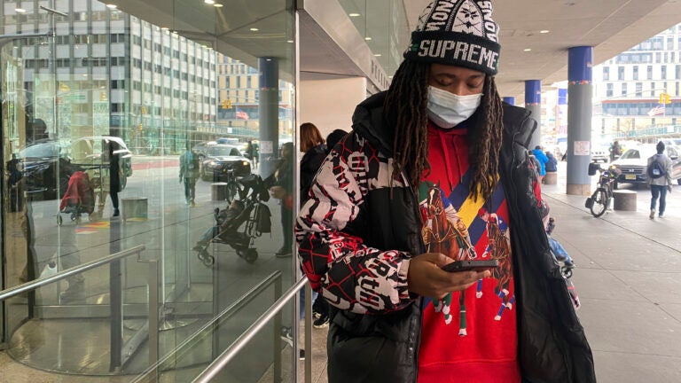 Frank Cope waits outside for a car after a checkup at Bellevue Hospital in New York.