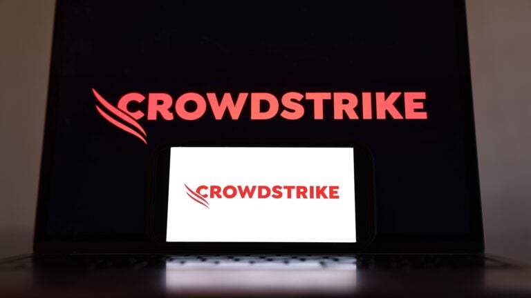 the CrowdStrike logo is displayed on a cell phone and computer monitor on July 19, 2024 in Los Angeles, California.